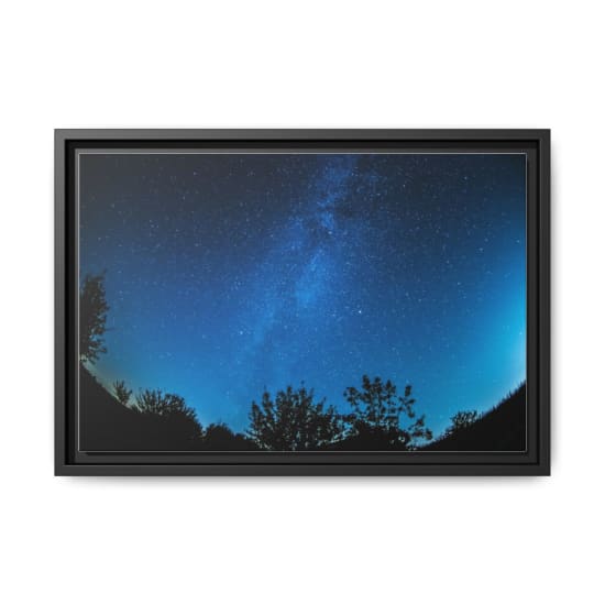 A breathtaking view of a starry night sky over a silhouetted forest, showcasing the Milky Way.
