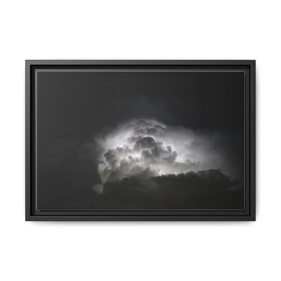 Powerful lightning illuminates dark storm clouds at night, creating a dramatic and mysterious sky.