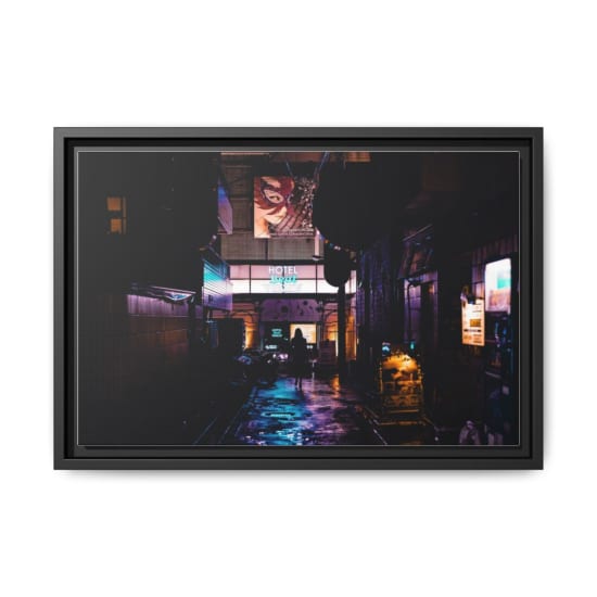 Silhouette of a person walking in a vibrant, neon-lit alleyway in Shinjuku, Tokyo at night.