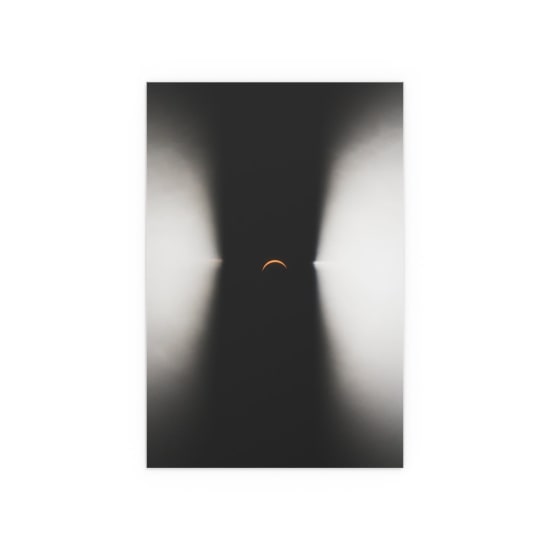 Abstract crescent moon set against an artistic light pattern, highlighting minimalism and contrast.