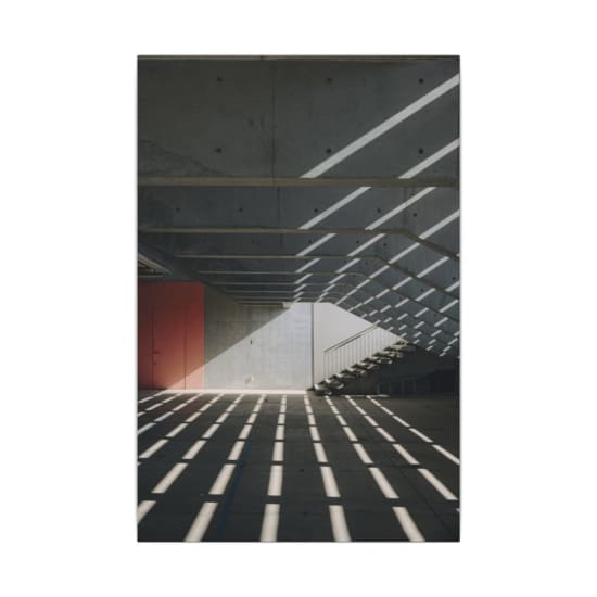 Concrete structure with dramatic shadows and staircase. Modern design.