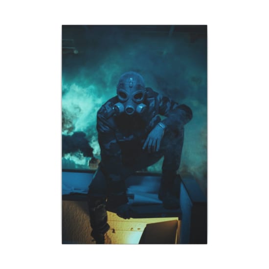 A mysterious figure in a gas mask sits in a smoky room, creating an eerie atmosphere.