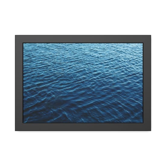 A calming view of dark blue ocean waves on a serene day outdoors.