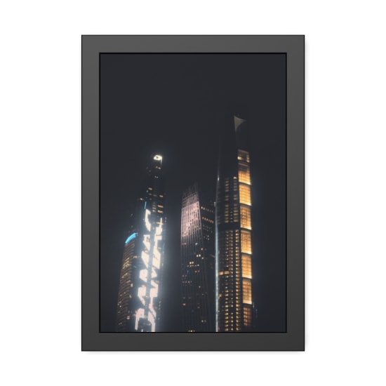 A stunning view of illuminated futuristic skyscrapers against the night sky, showcasing modern architectural design.