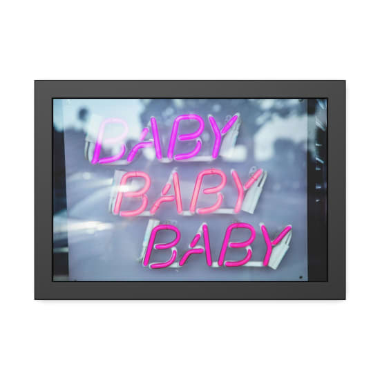 Bright pink neon sign repeating 'BABY' in a vivid eye-catching style.