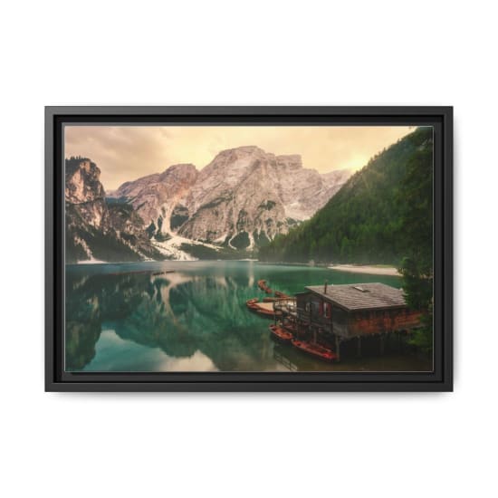 A breathtaking view of Lake Braies reflecting the Dolomite mountains at sunset.
