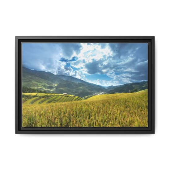 Beautiful terraced fields under a dramatic sky and mountain backdrop.