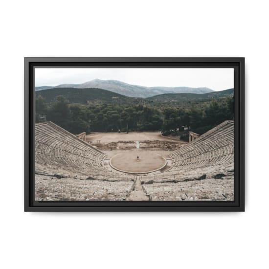 Majestic view of the ancient Greek theater amidst lush greenery and mountains.