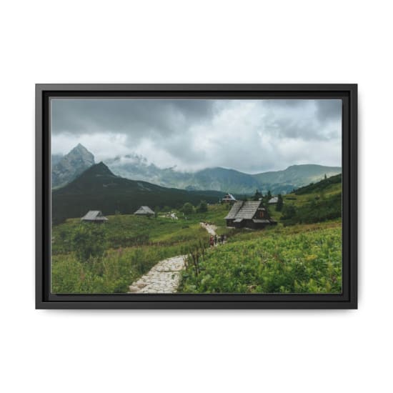 Charming wooden houses in the Tatra Mountains near Zakopane, Poland on a cloudy day.