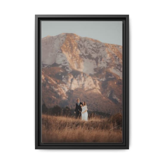 Bride and groom walking in the mountains at sunset, exuding romance and intimacy.