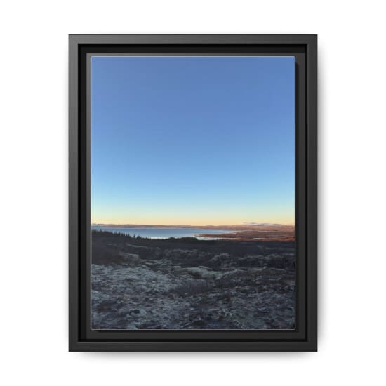 A stunning Icelandic landscape featuring frosted terrain and distant mountains under a clear sky.