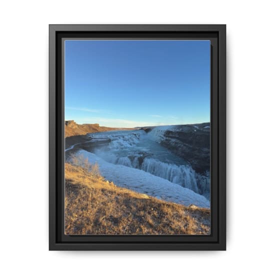 A stunning view of the Gullfoss waterfall in Iceland during winter surrounded by snow and ice.
