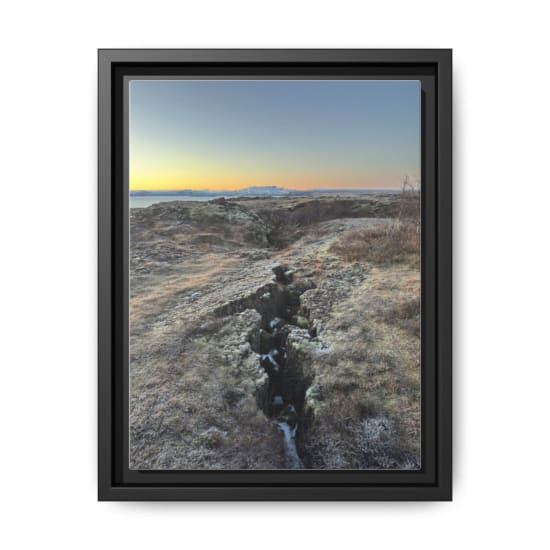 Breathtaking view of Iceland's rocky terrain and distant mountains at sunset.