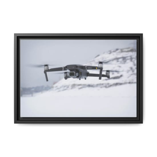 Close-up of a drone in flight over snowy terrain showcasing advanced technology.