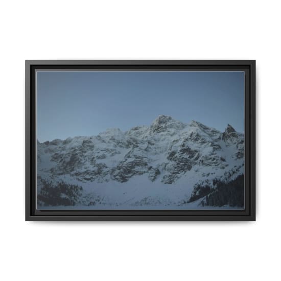 A serene view of snow-covered mountains under a clear sky, capturing winter's beauty in the High Tatras.