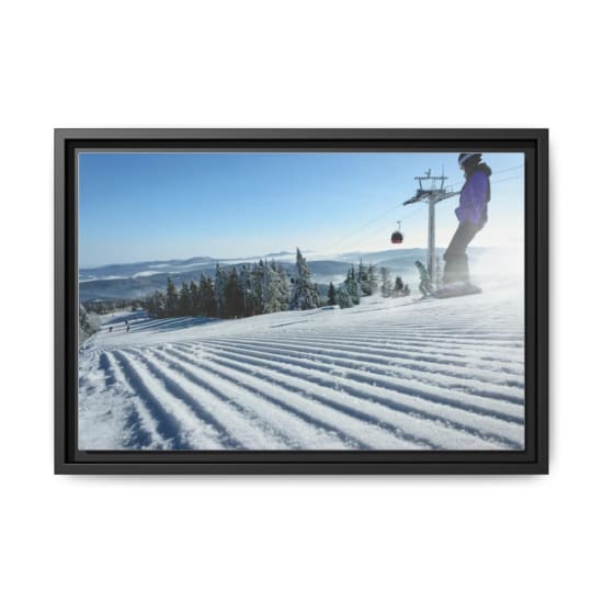 Winter scene of skiers on a snowy slope with cable car and clear sky