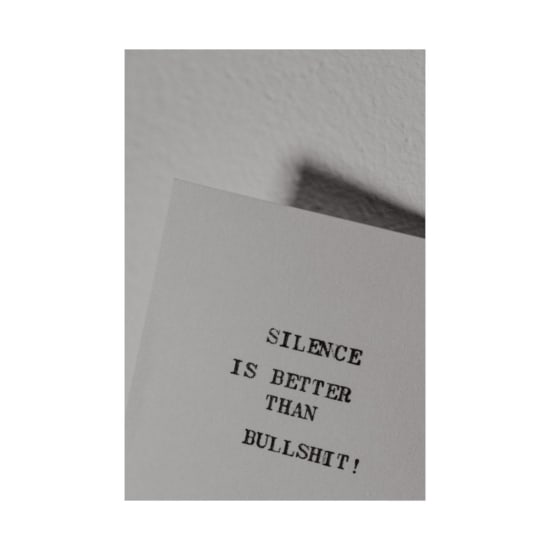 Monochrome image of a bold quote highlighting the value of silence over noise.