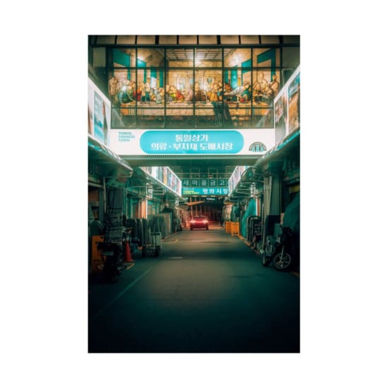 Illuminated market street in Seoul, showcasing vibrant neon lights and a bustling urban atmosphere.