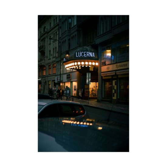 Night view of Lucerna Passage, a historical venue in downtown Prague, with glowing lights and urban ambiance.