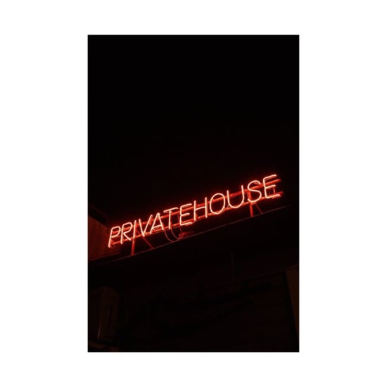 Red neon sign reading 'PRIVATEHOUSE' against a dark background. Perfect for urban or nightlife themes.