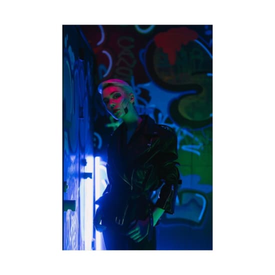 Cyberpunk-inspired portrait with vibrant neon lights and bold graffiti backdrop.