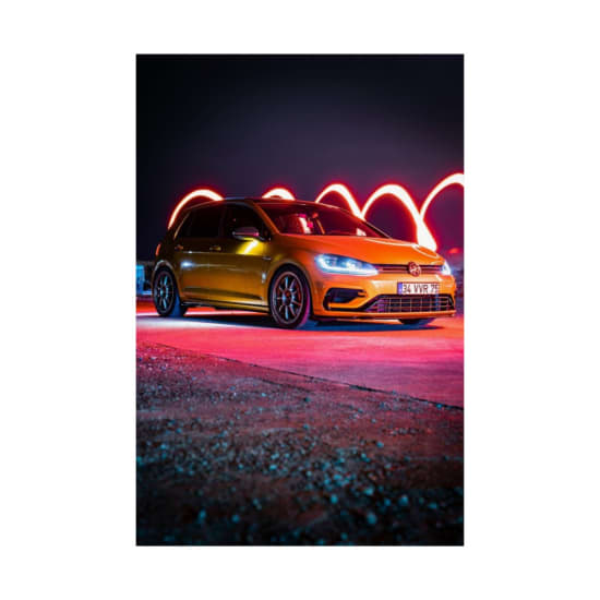 A striking urban scene featuring a car with vibrant night illumination and light trails.