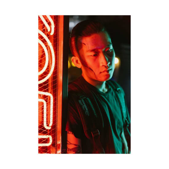 Portrait of a man in neon lights reflecting a cyberpunk style with futuristic vibes.