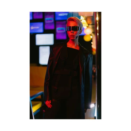 Stylish woman in cyberpunk attire with LED background lighting.