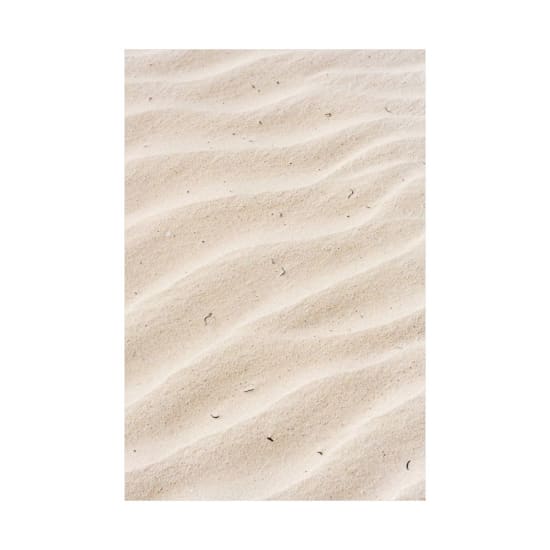 A textured view of sand ripples resembling desert dunes, ideal for background use.
