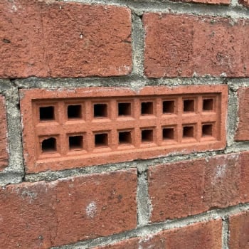 215mm x 65mm red air brick in a wall