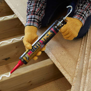 person using everbuild multi stick adhesive