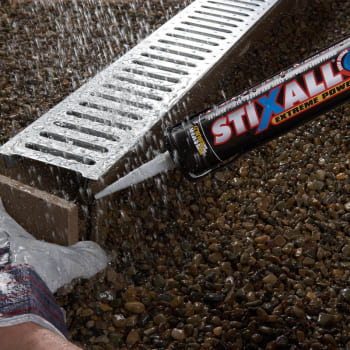 person using everbuild stixall adhesive on drain
