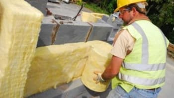 man installing party wall insulation