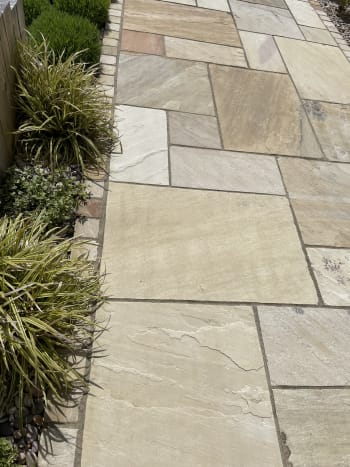 close up on mint indian sandstone paving installed