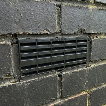 black plastic air brick in a wall