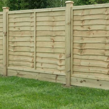 green treated timber gravel board in a fence