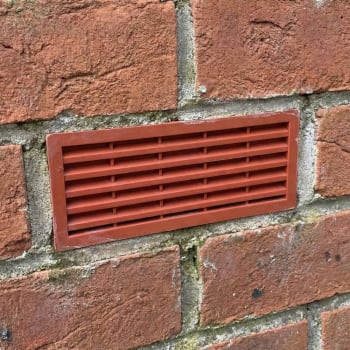 red plastic air brick in a wall