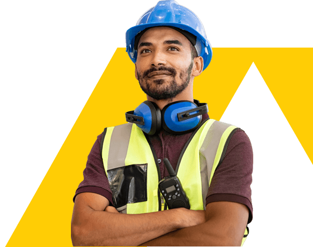 Trade person with crossed arms, and ear defenders round his neck