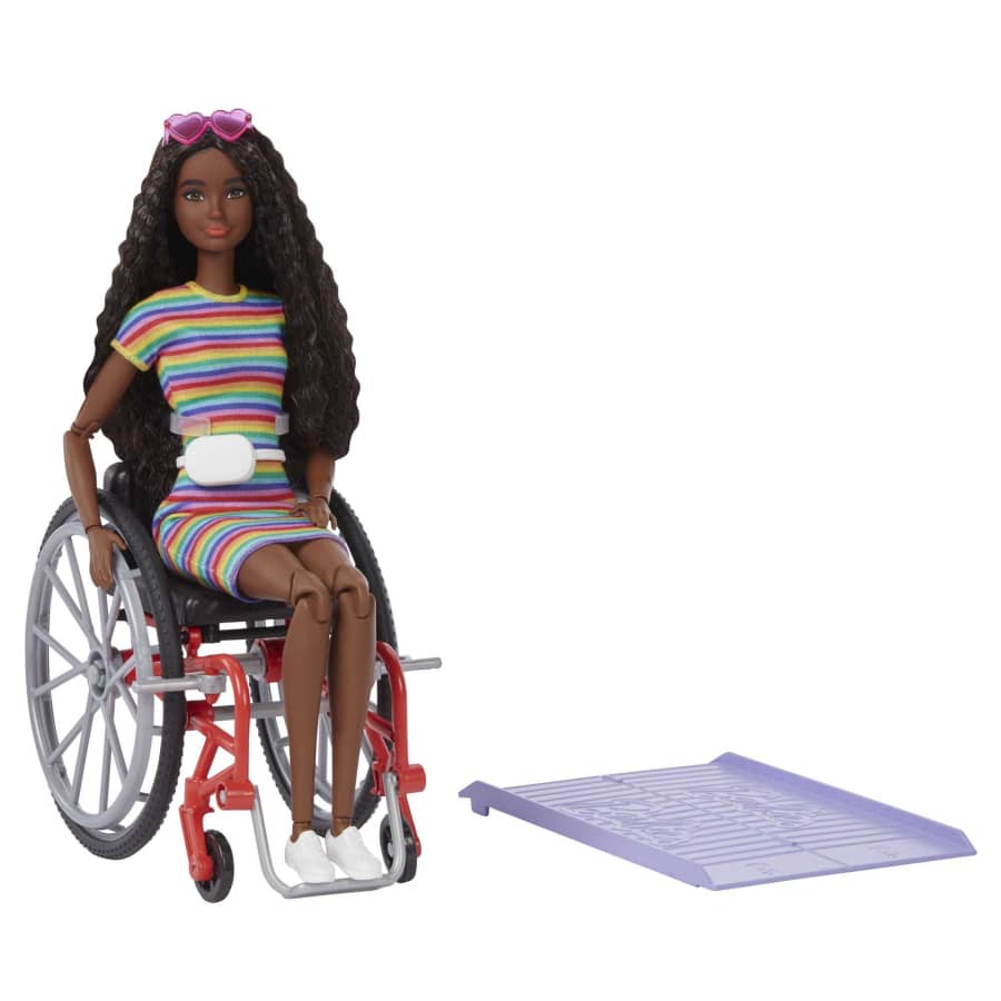 A Barbie doll sits in a wheelchair with a ramp nearby, from the Mattel store website