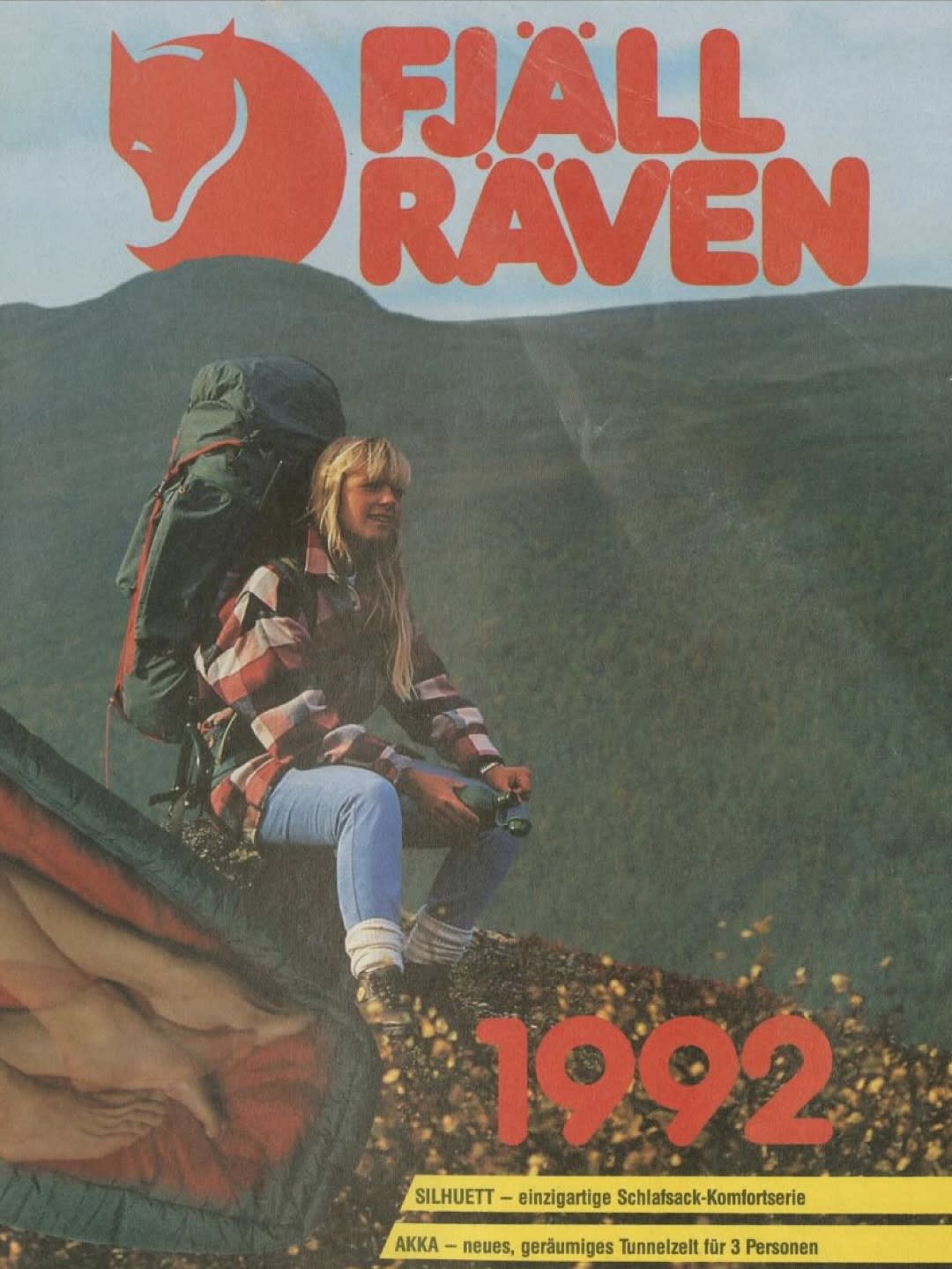 A blonde woman with a large backpack sits on a rocky slope in the foreground, with a mountainous landscape and the Fjällräven logo in the background.