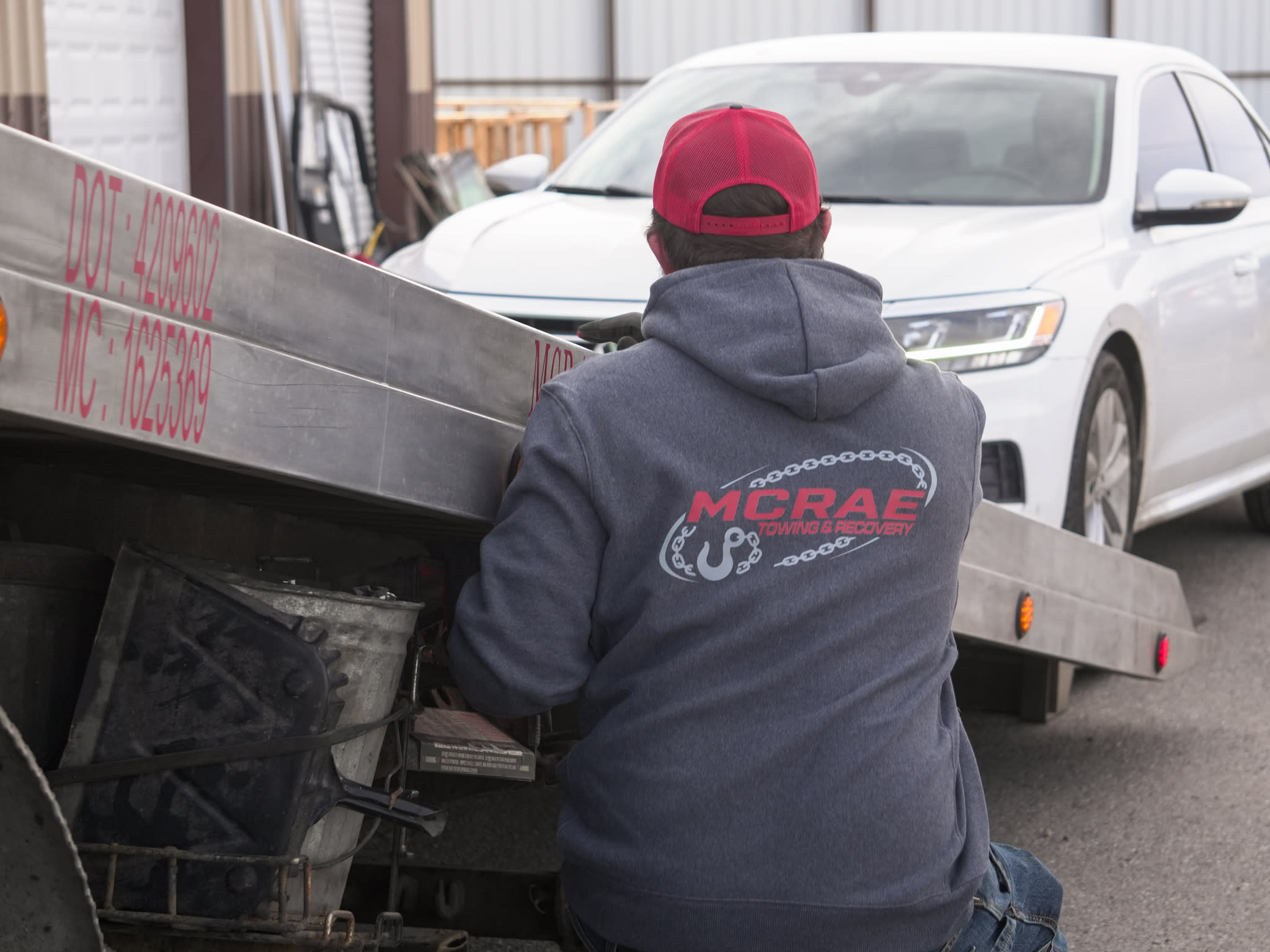 McRae Towing and Recovery flatbed loading a vehicle for transport.
