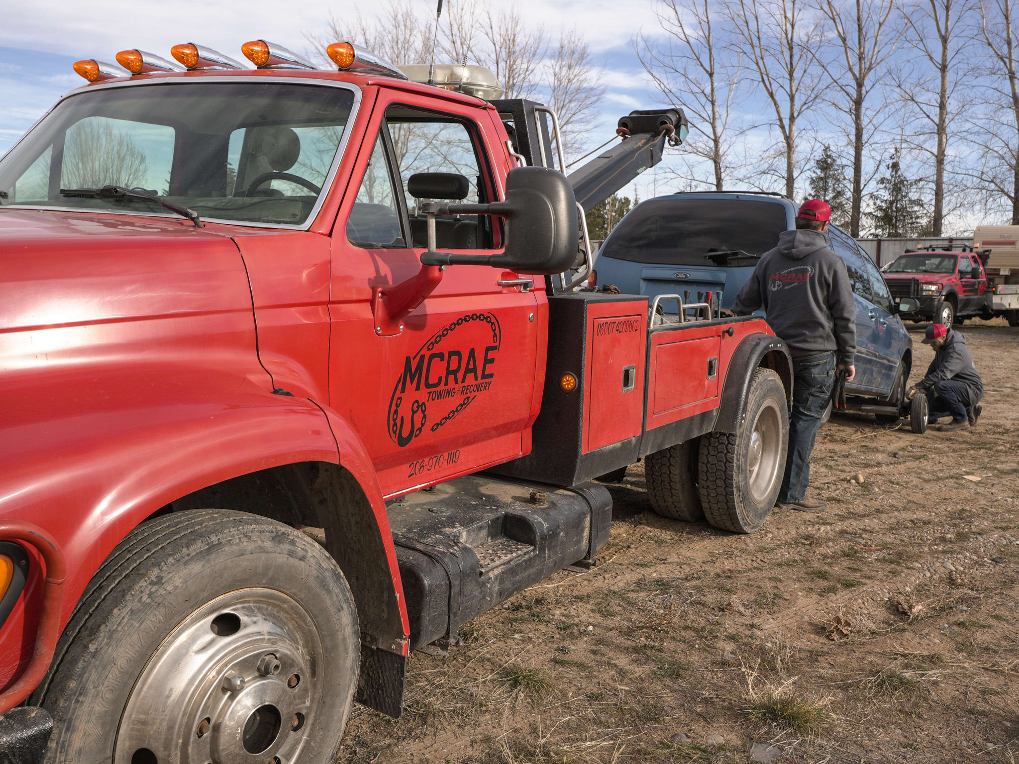 McRae Towing & Recovery wrecker dolly with a vehicle loaded for transport.