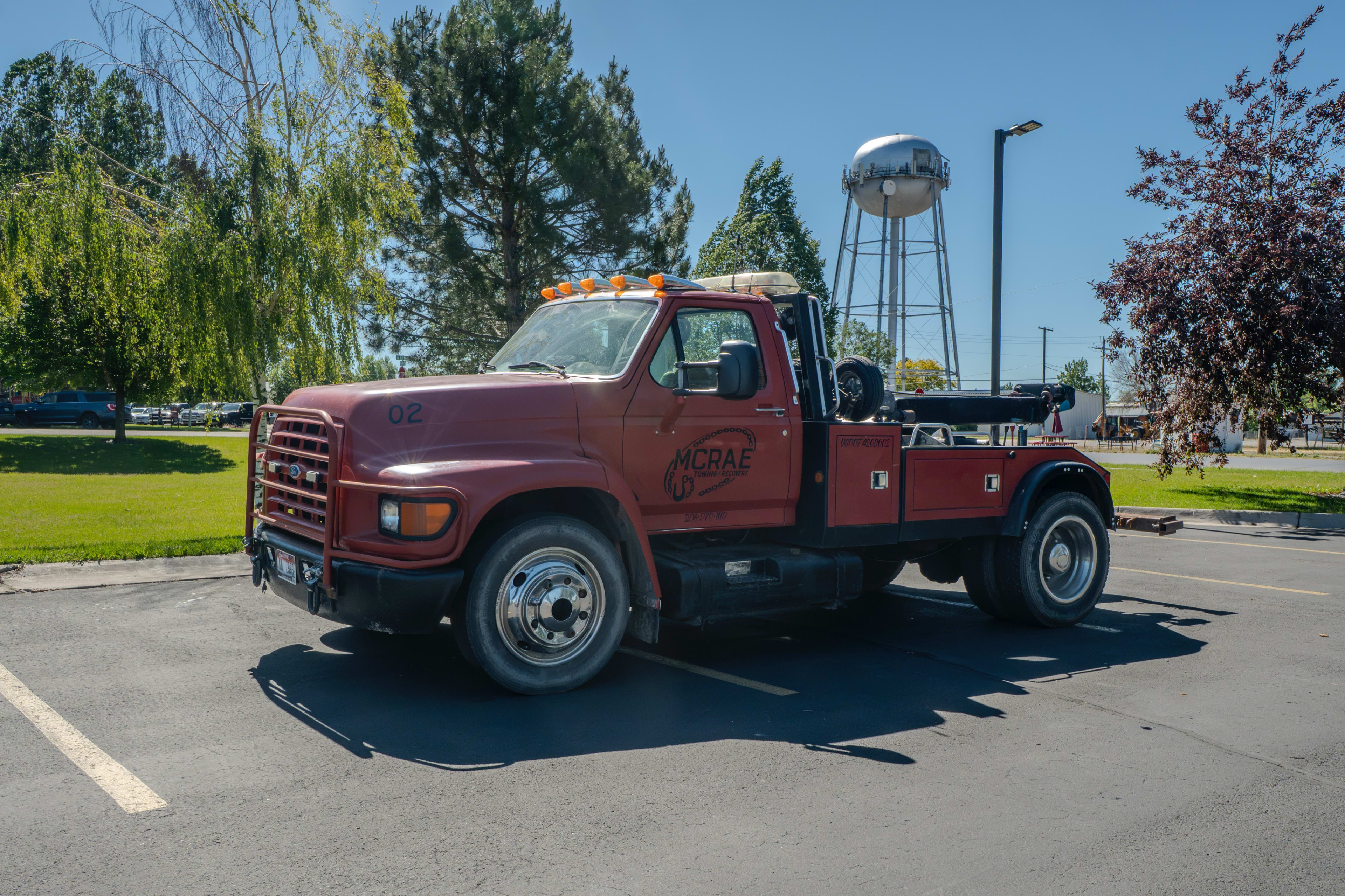 McRae Towing & Recovery wrecker parked in Rigby, Idaho with the local water tower in the background.