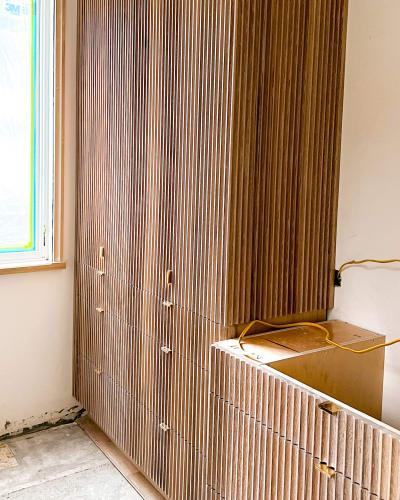 Fluted Cabinetry with Brass Accents