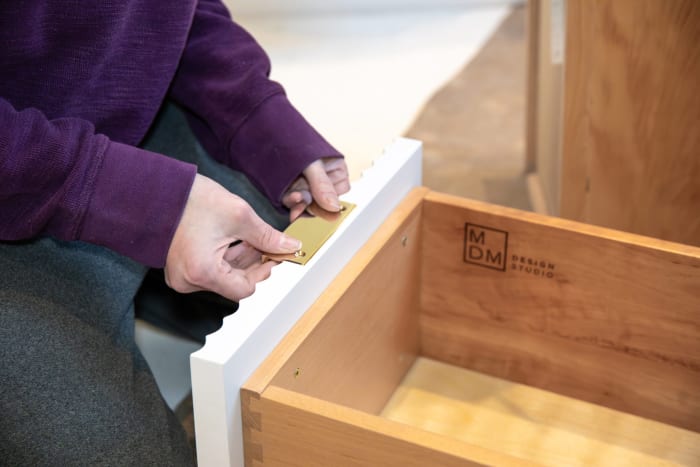 Installing Brass Hardware on Cabinet Drawer