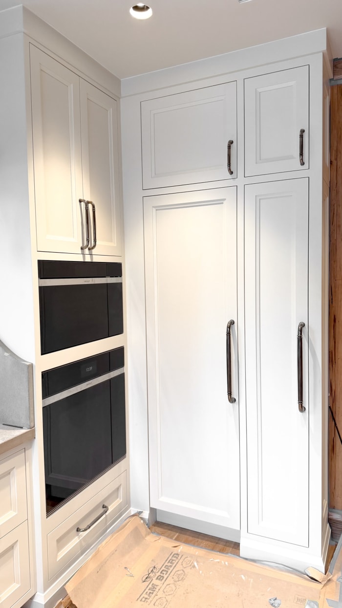White Cabinetry with Integrated Ovens and Storage