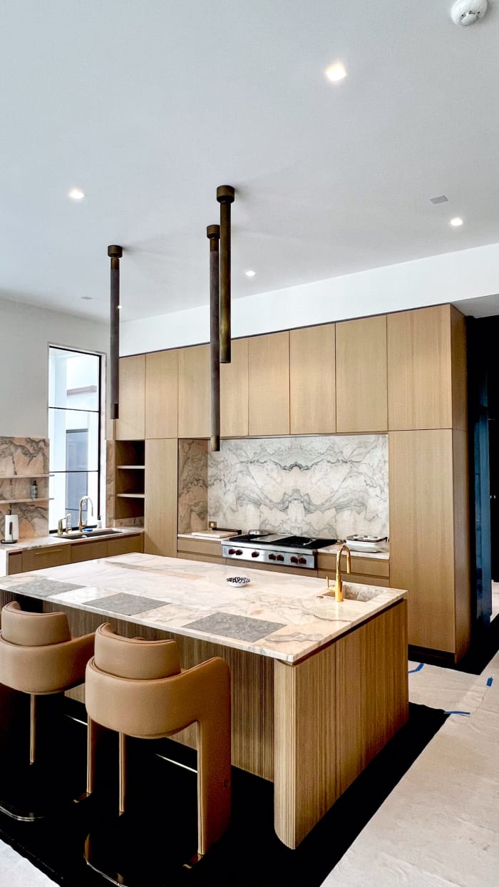 Reeded Kitchen Island with White Oak Cabinets and Marble Counters