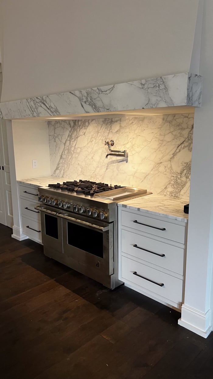Handcrafted Cabinetry with Marble Counters and Backsplash