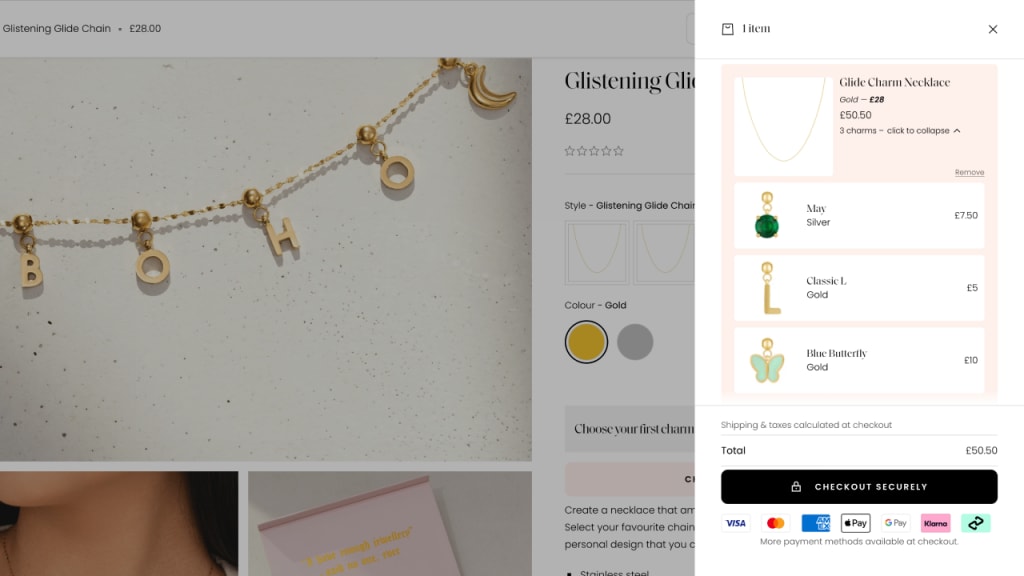 Cart drawer showing a Glide Charm Necklace in gold with three selected charms—May birthstone, Classic L, and Blue Butterfly—and total price before checkout