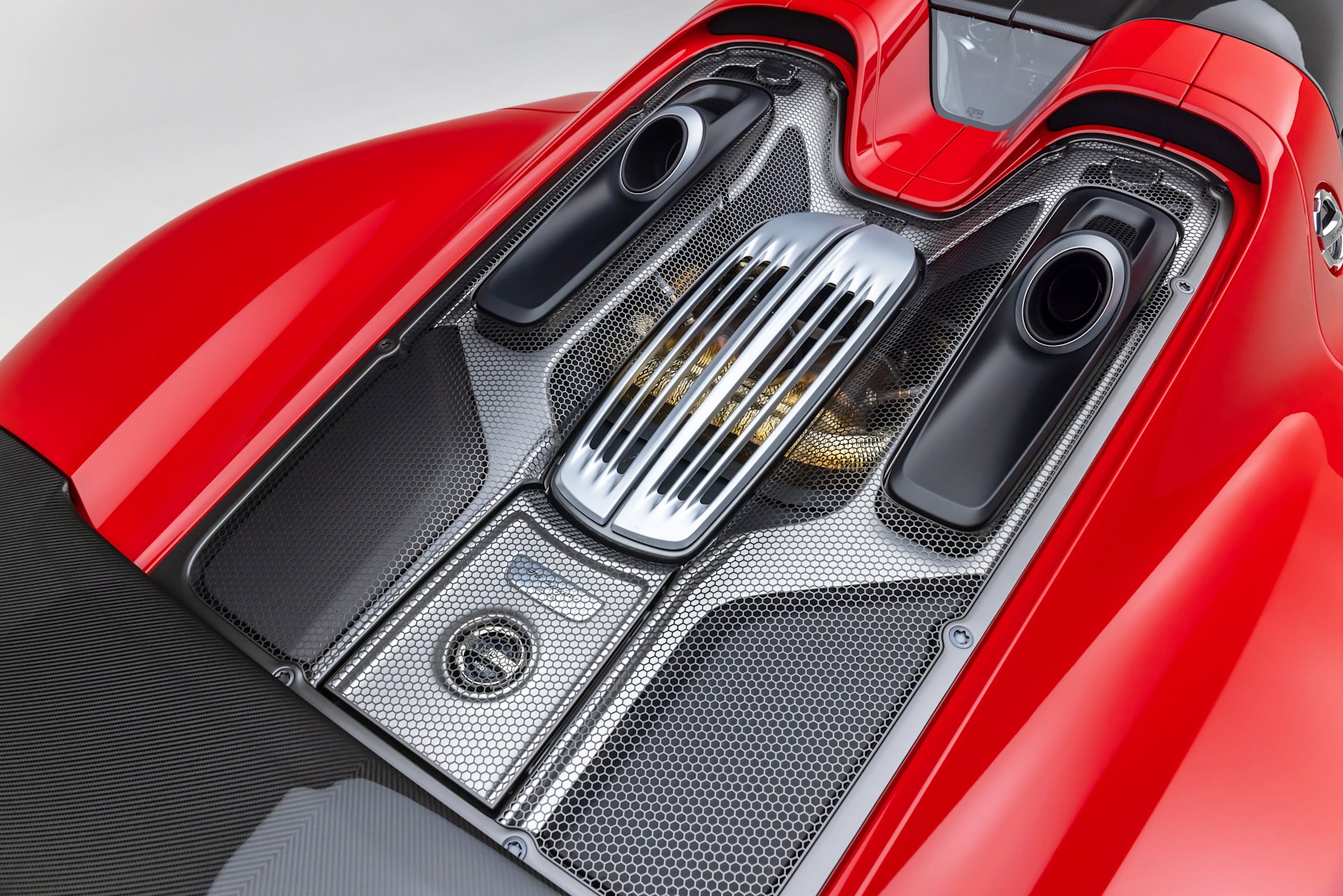 Engine bay detail of the 2015 Porsche 918 Spyder Weissach hybrid V-8, for sale on Mecum